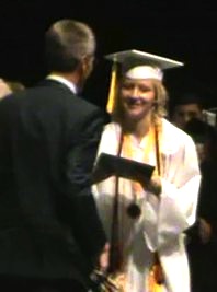 Class President Caitlyn Zona receives diploma from Principal Jim Tager.